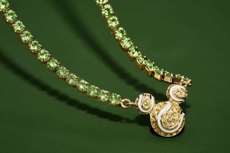 Our Disney Mickey Mouse tennis necklace, embellished with green and yellow pavé crystals. Mickey's silhouette adds a playful accent, reimagined as a trio of sparkling tennis balls.