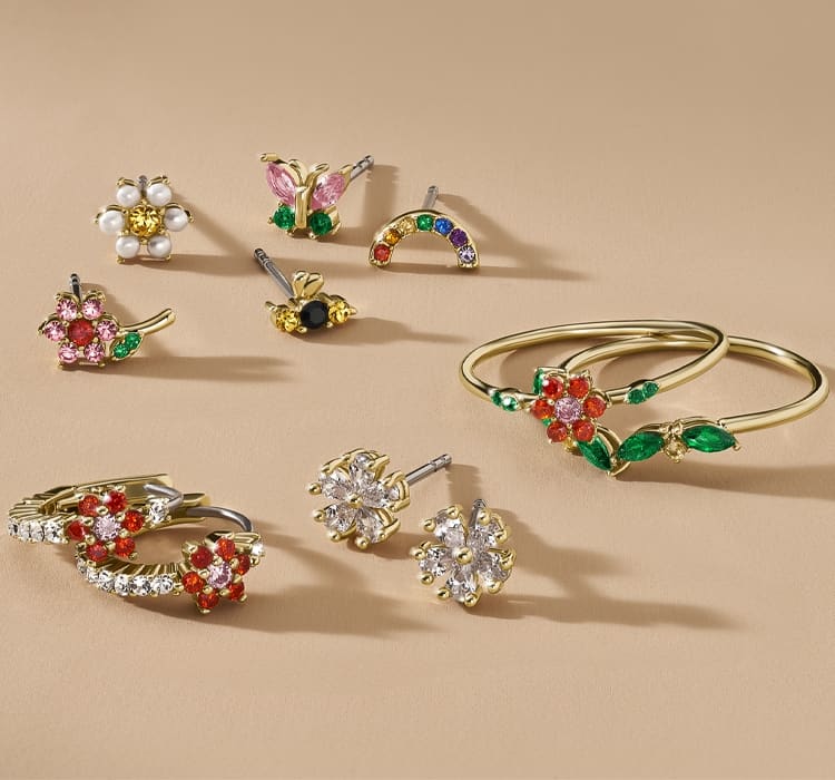 Ein GIF mit Ohrringen und Ringen mit bunten Glassteinen, die an einen Blumengarten erinnern.