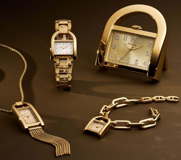 Four gold-tone pieces from the Harwell collection, including a Harwell watch, Harwell necklace, Harwell bracelet and desk clock.