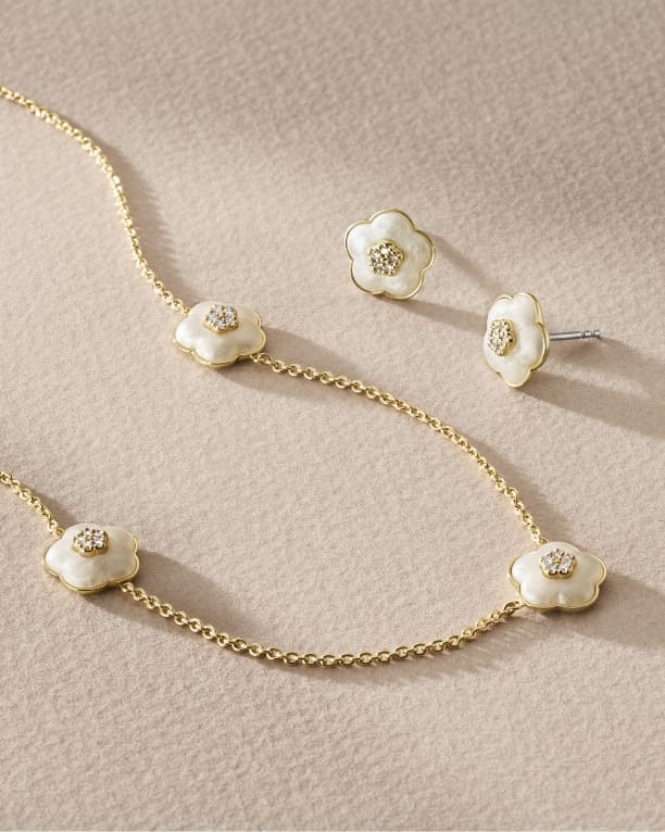 Delicate white resin floral jewellery featuring a crystal accent in the centre of each bloom.