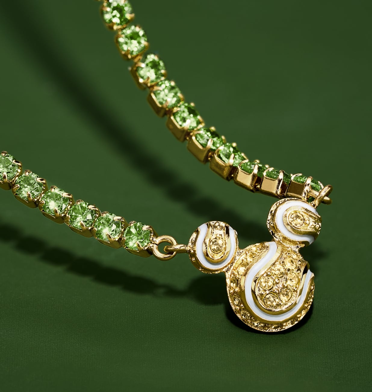 Our Disney Mickey Mouse tennis necklace, embellished with green and yellow pavé crystals. Mickey's silhouette adds a playful accent, reimagined as a sparkling trio of tennis balls.