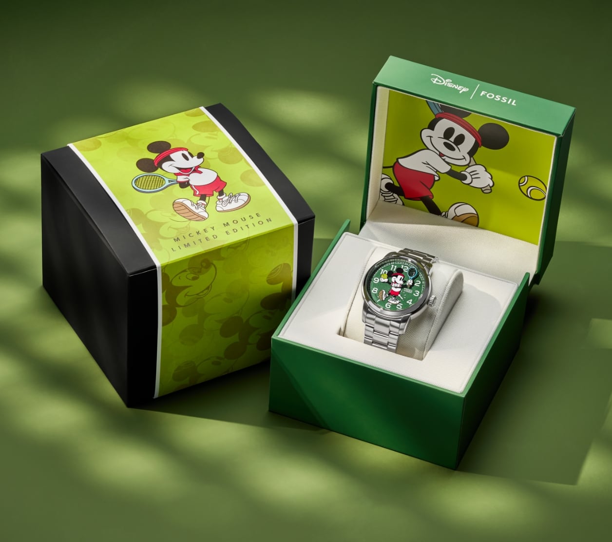 The keepsake gift box for our limited-edition Disney Mickey Mouse Tennis Watch, featuring custom Mickey Mouse graphics. On the left, the box is shown closed with a wraparound Mickey graphic. On the right, the box is shown open, revealing the watch inside and the custom Mickey graphic.